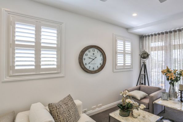 Sylish living room with new plantation shutters | Featured Image for the Plantation Shutters Brisbane Page of Shutters, Blinds & Awnings. 