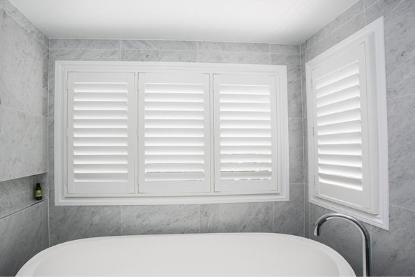 Sleek bath with new plantation shutters above it | Featured Image for the Plantation Shutters Brisbane Page of Shutters, Blinds & Awnings. 