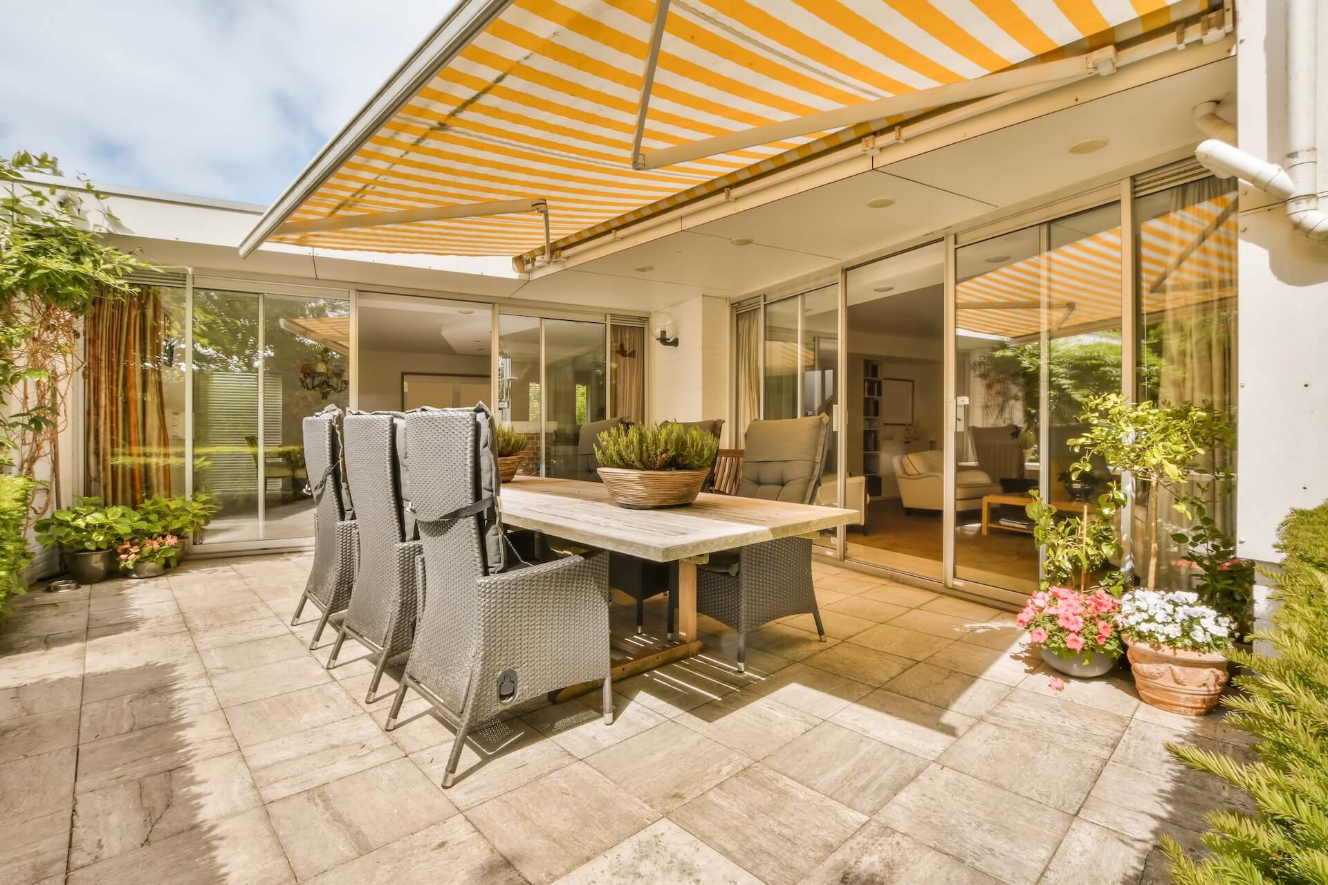 Outdoor blinds surrounding an alfresco seating area | Featured image for the Outdoor Blinds Brisbane Page on Shutters Blinds & Awnings.